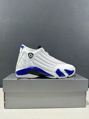 Side profile of a white and blue Jordan Air Jordan 14 sneaker on a gray shoe box.
