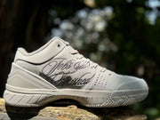 White Kobe 4 shoe showing decorative Mamba Mentality lettering