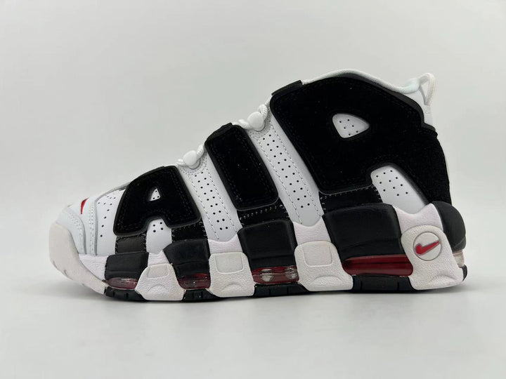Side view of a black and white Nike Air More Uptempo 96 sneaker with red accents