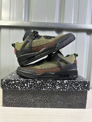 Two green and black low-top sneakers stacked to show the side profile, textured overlays, and sculpted midsole.