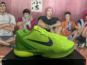Side profile of a green Nike basketball shoe with textured upper, black Swoosh, and lime-toned heel.