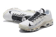 Angled view of the white sneakers highlighting black-and-white laces and multicolor speckling