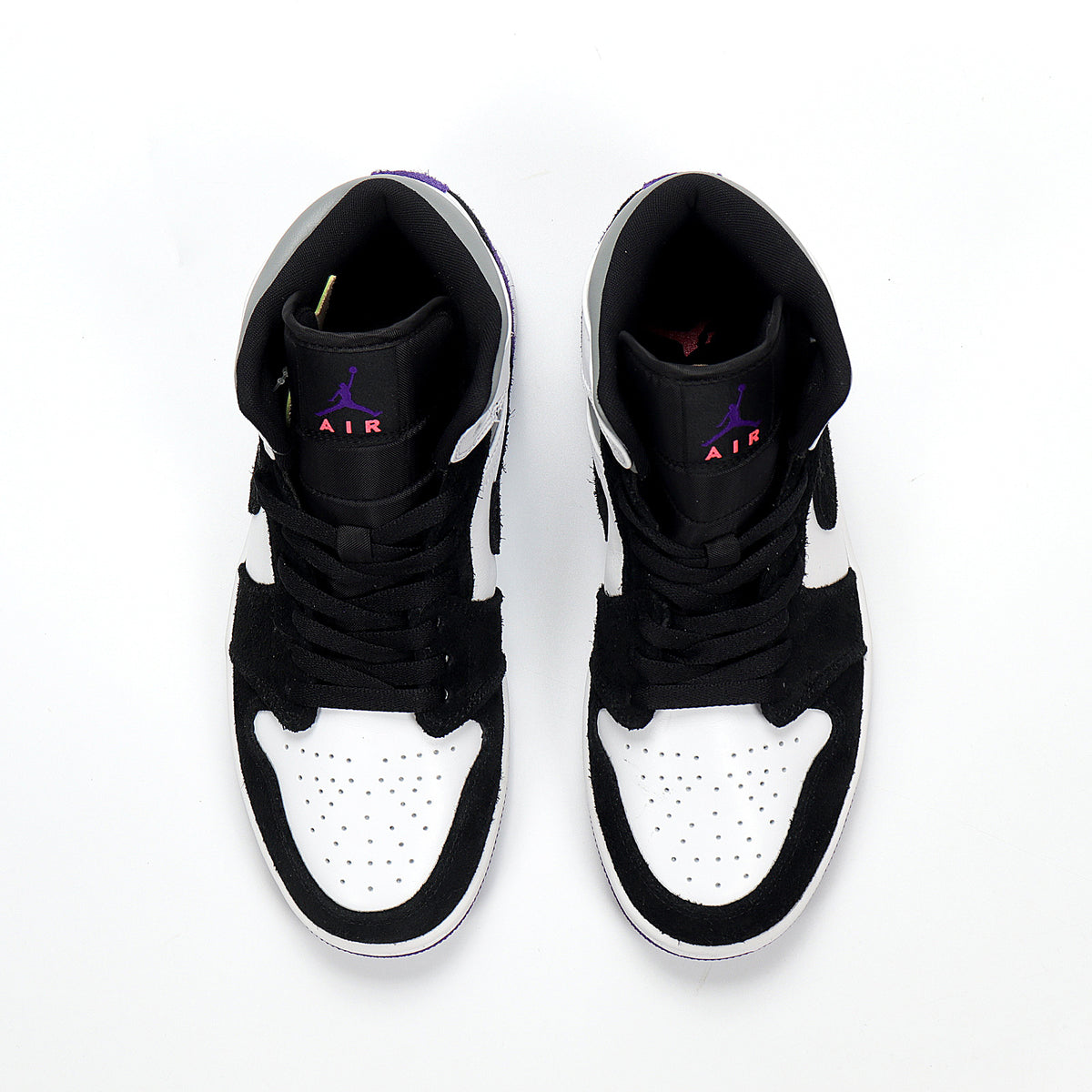 Top view of a pair of black, white, and purple high-top sneakers with black laces and Jordan branding on the tongues.