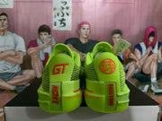 Rear view showing green heel panels, open-mesh sections, red detailing, and visible GT and EYBL-style markings.
