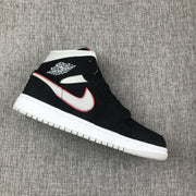 Single side view of the black mid-top sneaker with silver side branding and white sole.