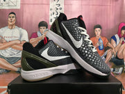 Pair of black and white basketball shoes shown from the sides, with textured uppers, white Swooshes, red accents, and dark heel panels.