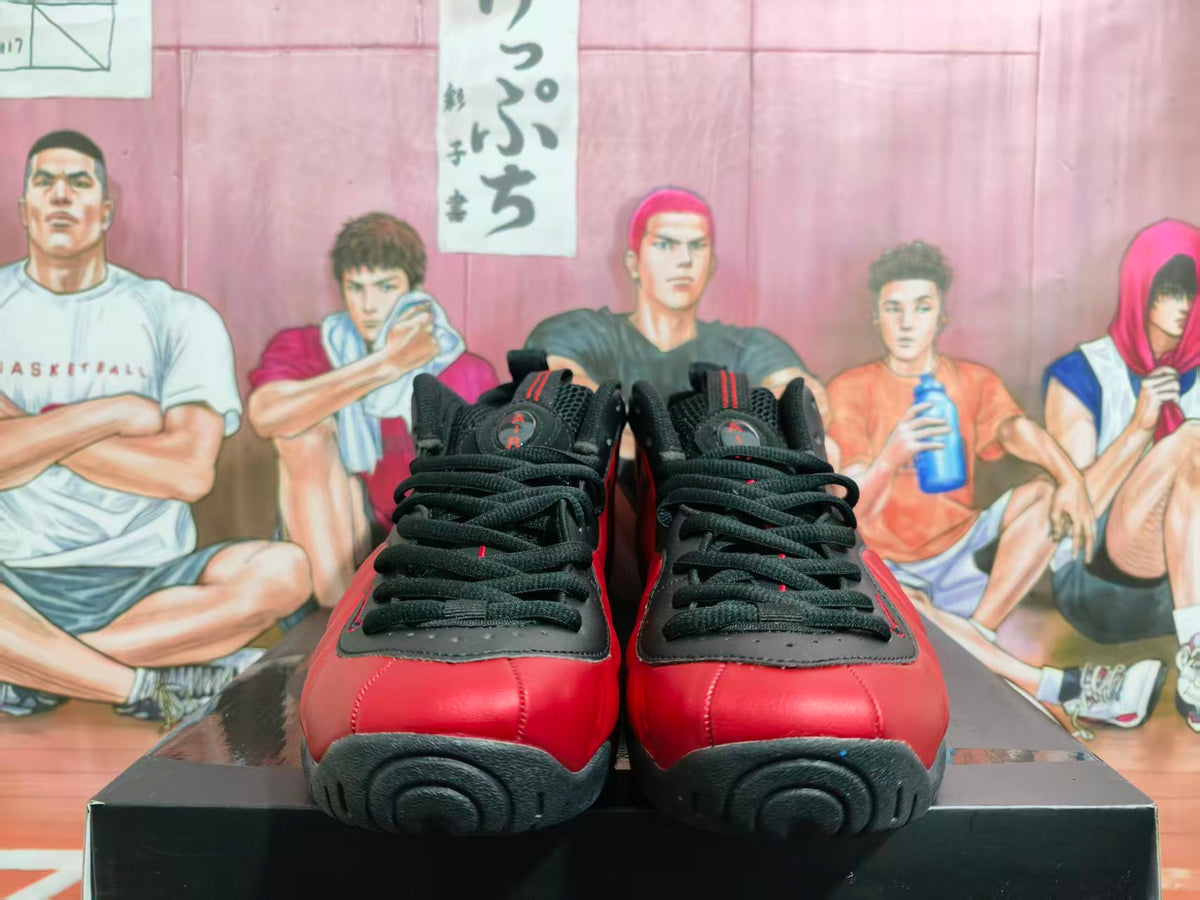 Front view of black and red Nike high-top sneakers with black laces and rounded black toe accents.