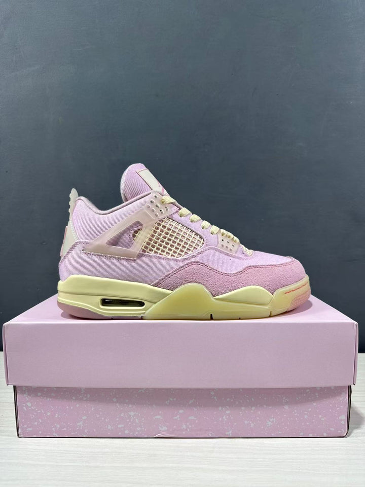 Side view of pink Jordan Air Jordan 4 Retro sneakers with pale yellow accents displayed on a pink shoebox.