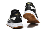 Rear and outsole view of black and white low-top sneakers.