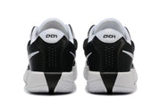 Rear view of black and white Nike G.T. Cut Academy shoes.