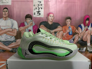 Side profile of a light green Jordan basketball sneaker showing layered black detailing, a gray speckled panel, Jumpman branding, and “Cushlon” text.