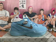 Side profile of a blue basketball sneaker showing the textured upper, dark side branding, sculpted midsole, and blue outsole.