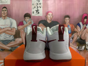 Rear view showing the white heel panels, burgundy pull tabs, and burgundy outsole edges.