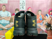 Rear view of the sneakers showing the gold Under Armour heel logos, padded collars, and outsole details.