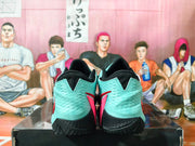 Rear view of Nike basketball shoes with aqua heels, black collars and outsoles, and red accents.