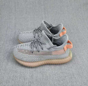 Pair of gray and coral Yeezy 350 V2 kids' sneakers shown at an angled front-side view.