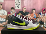 Side view of a Nike basketball sneaker showing perforated dark panels, burgundy laces, a neon green swoosh, and Zoom branding on the sole.