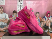 Pair of pink Nike basketball shoes shown from side and angled front views.