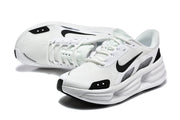Pair of white Nike sneakers with black accents, viewed from above