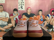 Front view of mauve and burgundy Nike Kobe basketball shoes with gum-colored outsoles