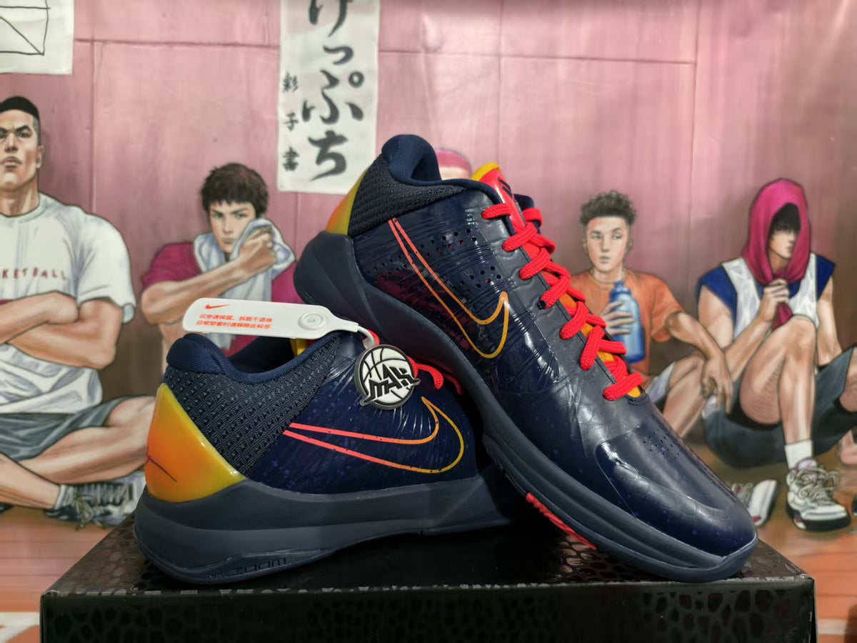 Pair of navy basketball sneakers with red laces, yellow-orange heel panels, and visible side Swooshes on a shoebox.
