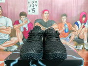 Front view of black textured Nike sneakers with black laces