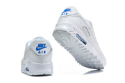 White Nike Air Max 90 sneakers shown from the heel and outsole.