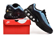 Side view of black and blue Nike sneakers displayed with a red Nike box