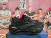 Black Brooks running shoes shown from the side with dotted heel details and sculpted soles.