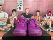 Front view of purple Nike basketball sneakers with matching laces, textured uppers, and rounded toe boxes.