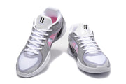 Pair of white and grey Nike basketball shoes with pink side accents, viewed from the front.