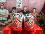 Rear view showing the patterned heel panels, blue lettering, white collars, and orange outsoles.
