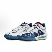 Pair of white and navy Nike basketball sneakers with blue outsole sections.