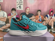 Side profile of a teal sneaker with red and black graphic detailing, white midsole, and padded collar.