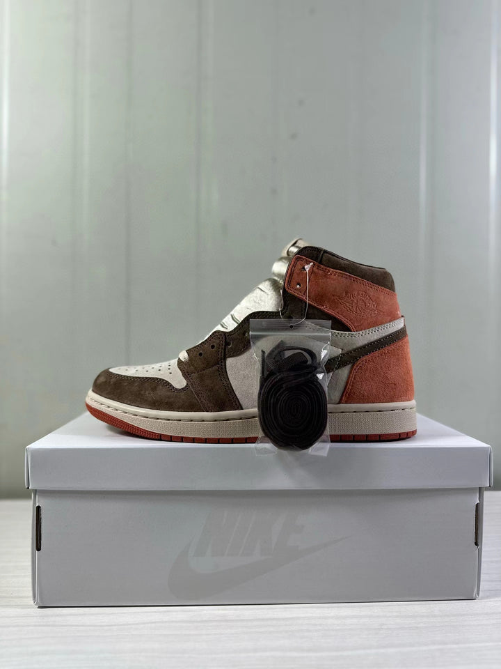 Side view of a brown, neutral, and rust-colored Air Jordan 1 high-top beside its box