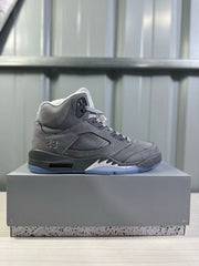 Side profile of a grey high-top sneaker showing the padded collar, stitched panels, side ventilation panel, number 23 detail, and translucent outsole.