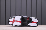 Underside showing the black and white outsole with red accents.