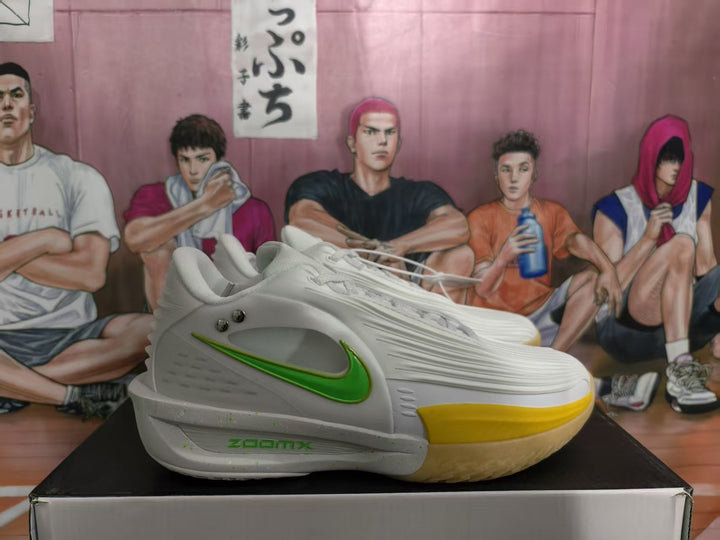 Side view of white Nike basketball sneakers with a green Swoosh, yellow forefoot accent, and visible ZoomX midsole branding.