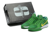 Green Nike Sabrina 2 basketball shoes beside a black Sabrina 2 shoe box.