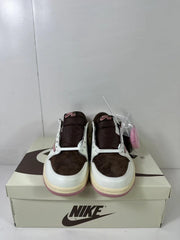 Front view of the low-top sneakers in brown, white, cream, and muted pink, displayed on a shoebox.