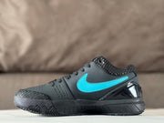 Opposite side profile showing the black and turquoise sneaker, perforated forefoot, textured toe panel, and patterned outsole.