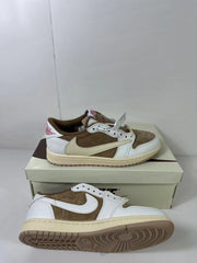 Angled view of the pair showing the low-top silhouette, brown and white upper, cream Swoosh, and visible outsole tread.