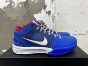 Side view of blue Nike Kobe basketball shoes with white Swoosh, fine-line graphics, and white midsoles.