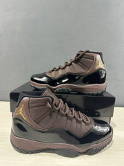 Close angled view of the black patent-style lower upper, bronze textile panels, and high-top collar.