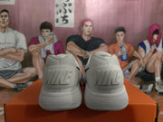 Rear view of the white sneakers showing raised Nike branding on the heels.