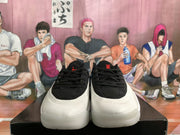 Front view of the pair showing black laces and uppers, white toe sections and red tongue logos.