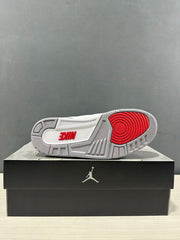 Outsole view showing a grey rubber base and red circular traction section on the sneaker.