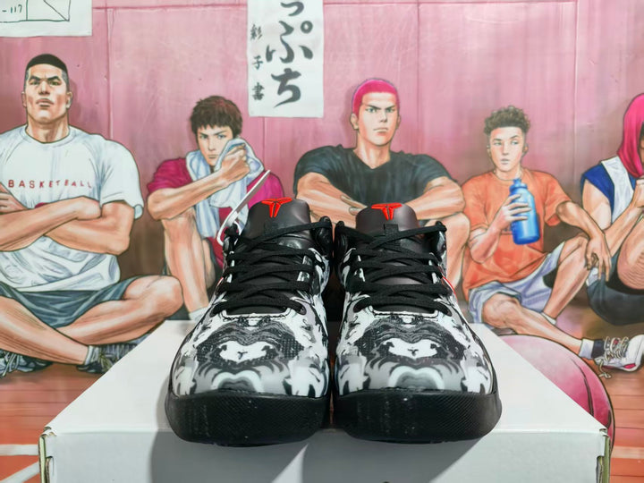 Front view of black and red Nike basketball sneakers with a grayscale patterned toe and black laces.