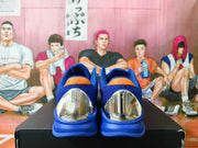 Rear view highlighting the metallic-looking heel panels and blue heel counters of the Nike Kobe shoes.