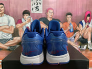 Rear view of blue Nike basketball shoes showing padded collars, white midsoles, blue outsoles, and red signature-style details.
